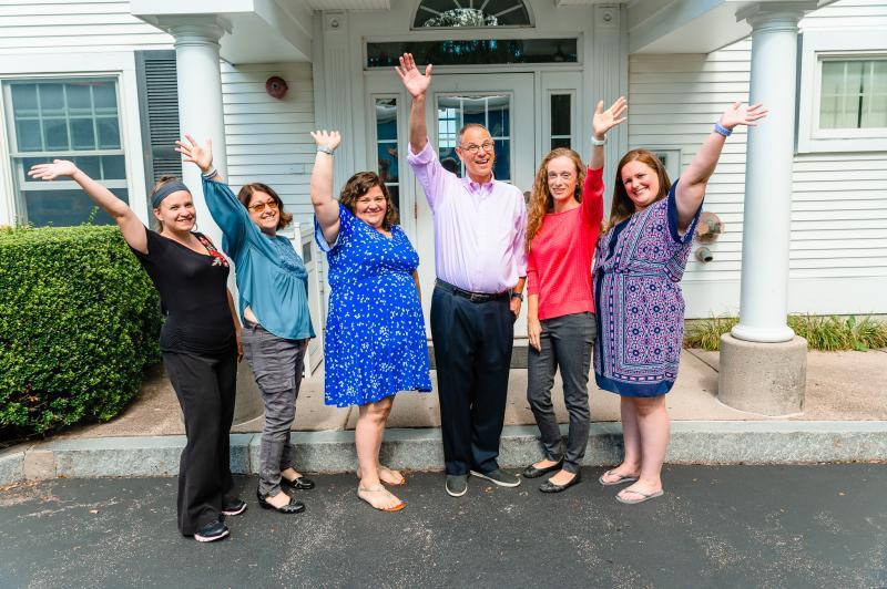 a group of people waving